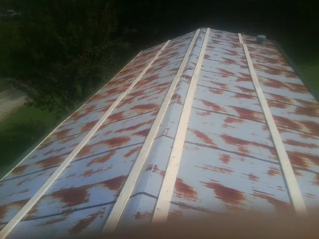 Rusted metal roof panels with new wood purlins before replacement — Storm Damage Roof Repair in Goose Creek by Roofing Brothers